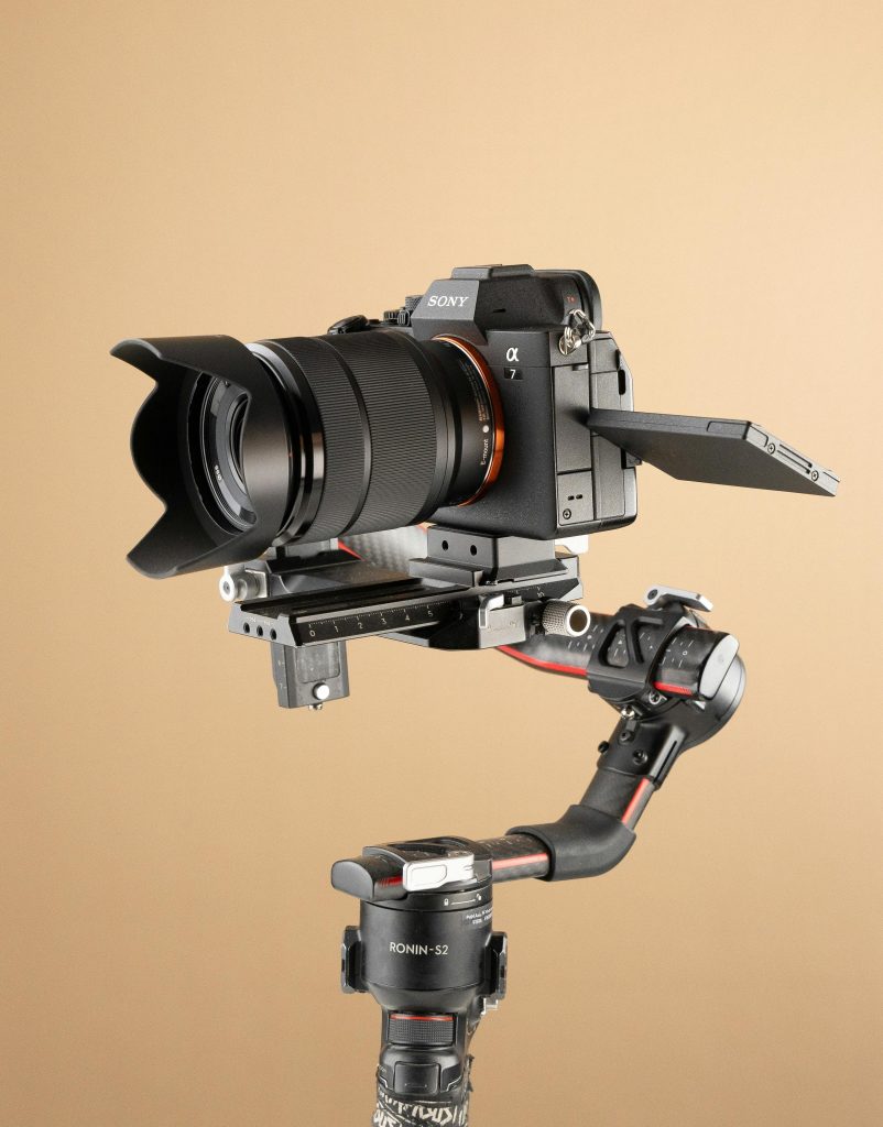 High-quality mirrorless camera mounted on a stabilizer against a neutral background.