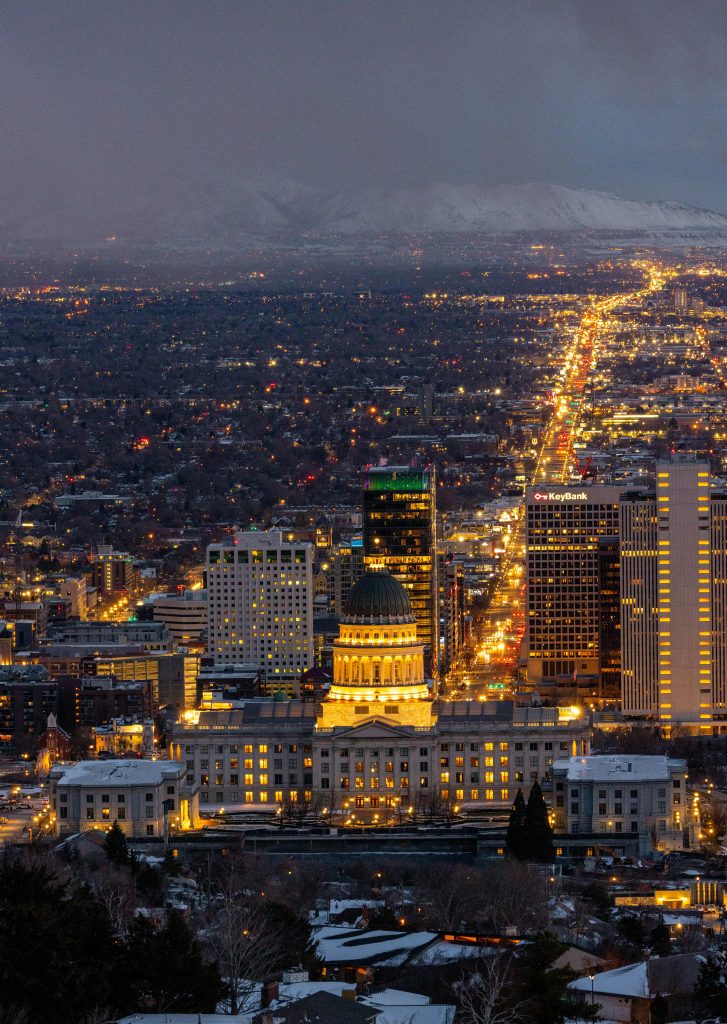 Captivating aerial shot of Salt Lake City's skyline illuminated at night with the Capitol building prominently visible.