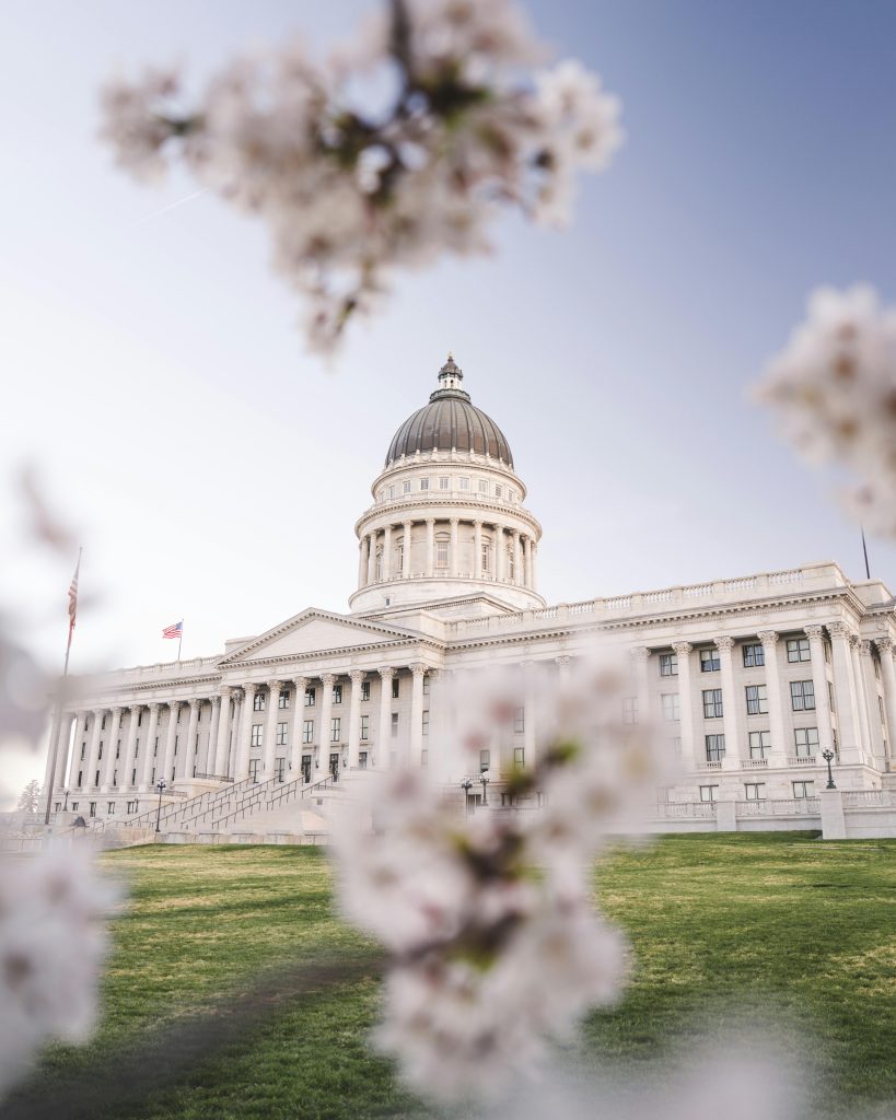 A captivating view of the Utah State Capitol surrounded by blooming cherry blossoms, showcasing spring beauty.